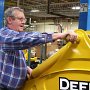 MAY – Honorable Mention - Seniority Gets You the Big Jobs<br />Bonnie Polster, Local Lodge 1260, Amerequip Corporation, Kiel, WI<br />John Skahen, a 23-year member, assembles an industrial-sized John Deere backhoe.<br />